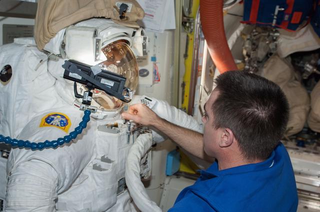 Cassidy in Quest airlock with malfunctioning EMU