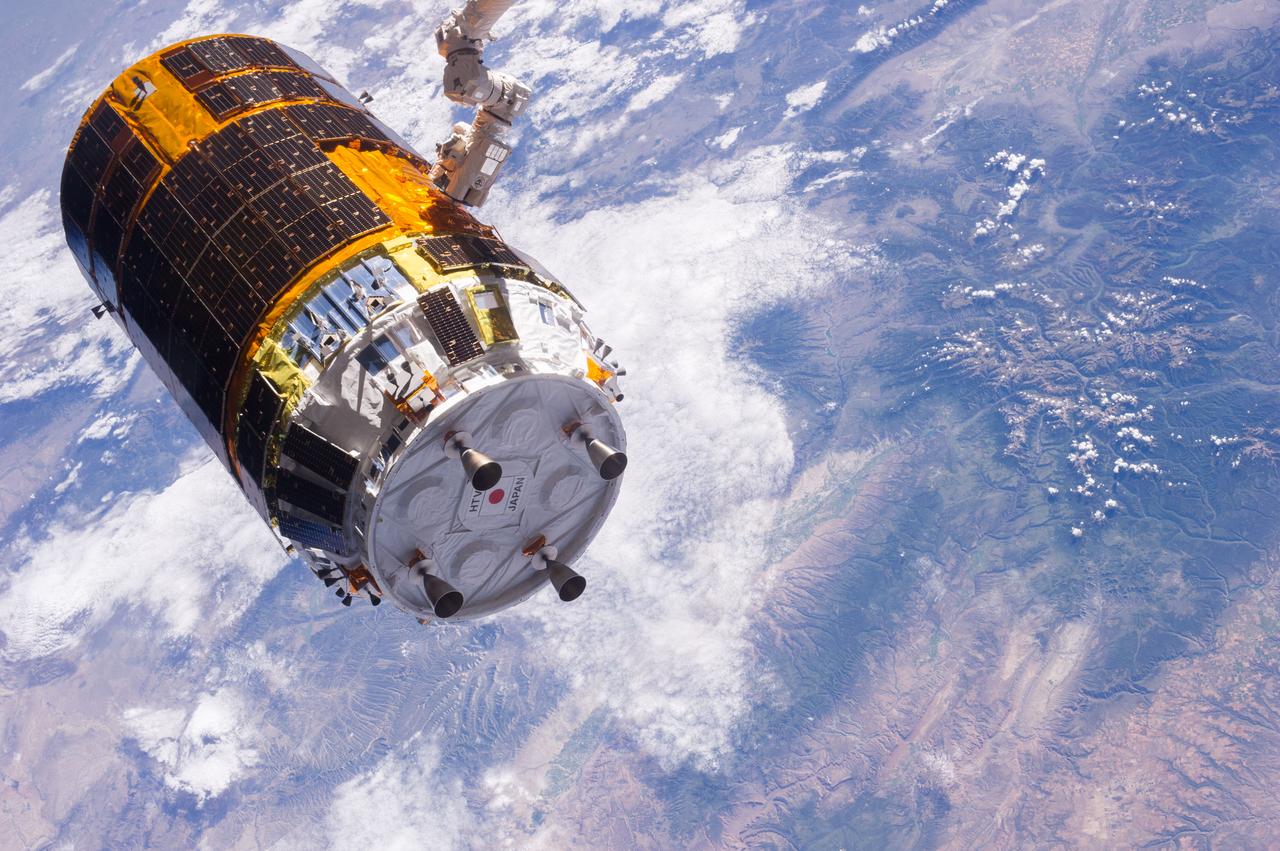 One of the Expedition 36 crew members aboard the International Space Station took this picture of the Japanese HTV-4 unmanned cargo spacecraft,backdropped against a land mass on Earth,following its unberthing but just prior to its release from the orbital outpost's Canadarm2. HTV-4,after backing away from the flying complex,headed for re-entry into Earth's atmosphere,burning upon re-entry. Per Twitter message: Flying over southwestern US, not long before release of #HTV4 by #Canadarm2.