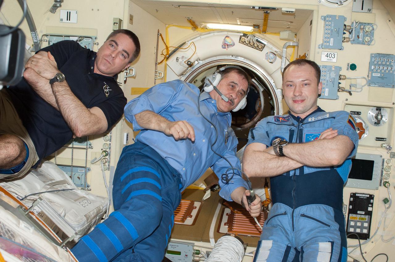 ISS036-E-048259 (10 Sept. 2013) --- Russian cosmonaut Pavel Vinogradov (center), Expedition 36 commander; along with NASA astronaut Chris Cassidy (left) and Russian cosmonaut Alexander Misurkin, both flight engineers, are pictured in the Poisk Mini-Research Module 2 (MRM2) of the International Space Station as they prepare to depart from the station and return to Earth.