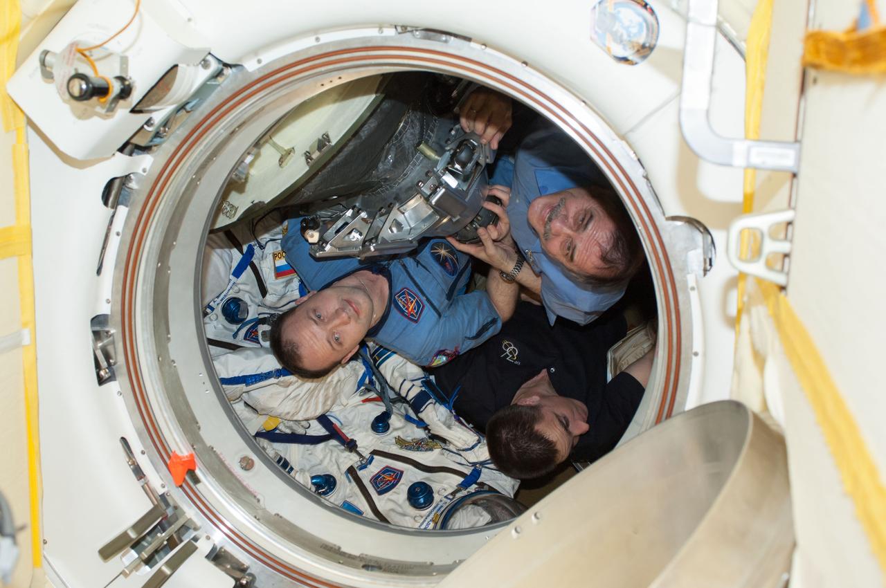 ISS036-E-048265 (10 Sept. 2013) --- Russian cosmonaut Pavel Vinogradov (top right), Expedition 36 commander; along with NASA astronaut Chris Cassidy (bottom right) and Russian cosmonaut Alexander Misurkin, both flight engineers, are pictured in the Soyuz TMA-08M spacecraft currently docked to the Poisk Mini-Research Module 2 (MRM2) of the International Space Station. The trio is preparing to undock from Poisk in their Soyuz spacecraft, ending a five-and-a-half month stay at the station.