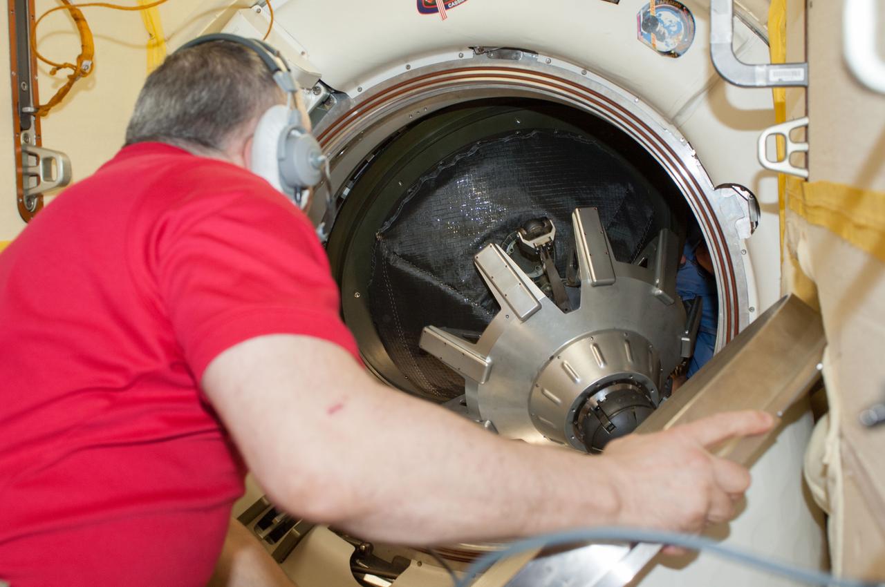 ISS036-E-048271 (10 Sept. 2013) --- Russian cosmonaut Fyodor Yurchikhin, Expedition 37 commander, closes the hatch between the Soyuz TMA-08M spacecraft and the International Space Station’s Poisk Mini-Research Module 2 (MRM2) as the three Expedition 36 crew members prepare to undock from the station.