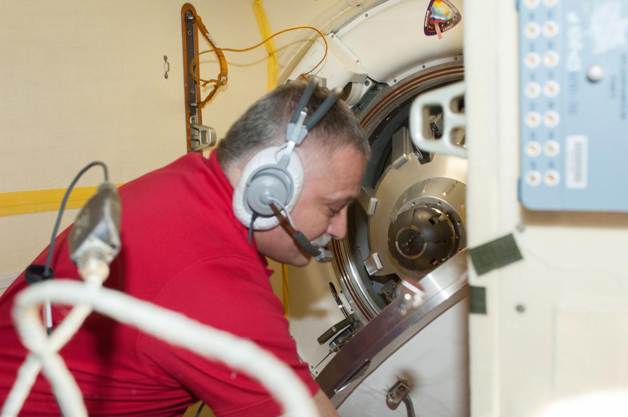 ISS036-E-048274 (10 Sept. 2013) --- Russian cosmonaut Fyodor Yurchikhin, Expedition 37 commander, closes the hatch between the Soyuz TMA-08M spacecraft and the International Space Station’s Poisk Mini-Research Module 2 (MRM2) as the three Expedition 36 crew members prepare to undock from the station.