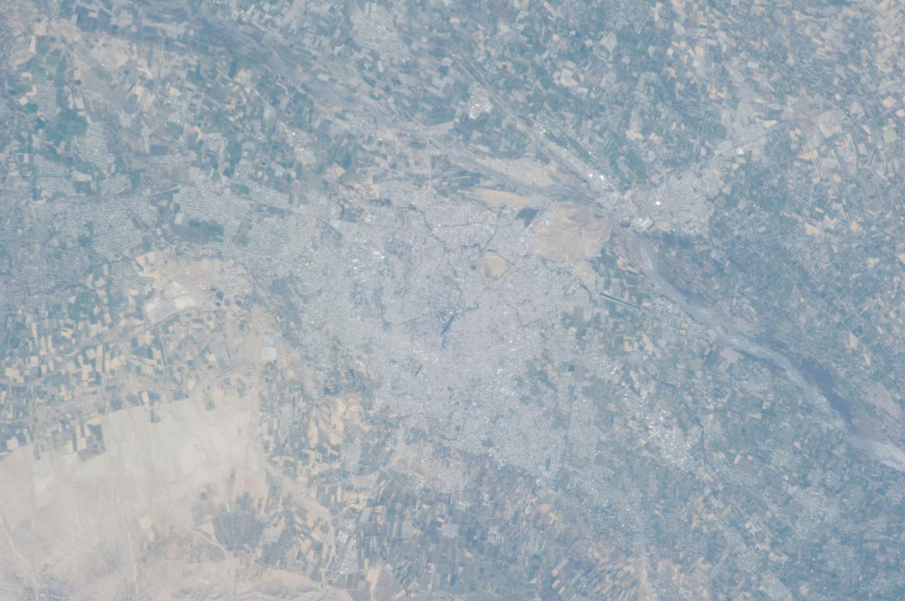 ISS037-E-000719 (13 Sept. 2013) --- Samarkand, Uzbekistan is featured in this image photographed by one of the Expedition 37 crew members aboard the International Space Station.  The historical Silk Road provided trade routes between Asia and Europe as far back as 208 BC according to historical accounts. And, parts of the Silk Road are still used for the transport of goods today.  The city of Samarkand is one of the oldest and historically most important cities along the   road, occupying a central position  between China and the western nationas of Europe,  Today, Samarkand is the second largest city in the Republic of Uzbekistan (formed in 1991).  The urban area (center) is located within a large oasis situated in the Zerafshan River Valley of southeastern Uzbekistan.