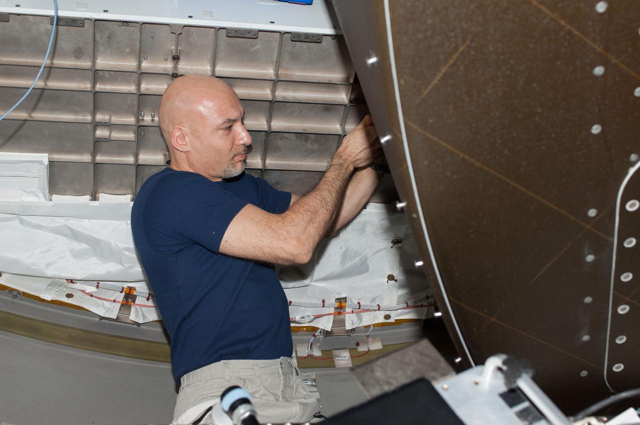 ISS037-E-001078 (12 Sept. 2013) --- European Space Agency astronaut Luca Parmitano, Expedition 37 flight engineer, performs in-flight maintenance behind a rack in Tranquility node of the International Space Station. Parmitano replaced a mass spectrometer inside the Major Constituent Analyzer (MCA). The MCA measures the levels of nitrogen, oxygen, carbon dioxide, methane, hydrogen and water vapor inside the space station’s atmosphere.