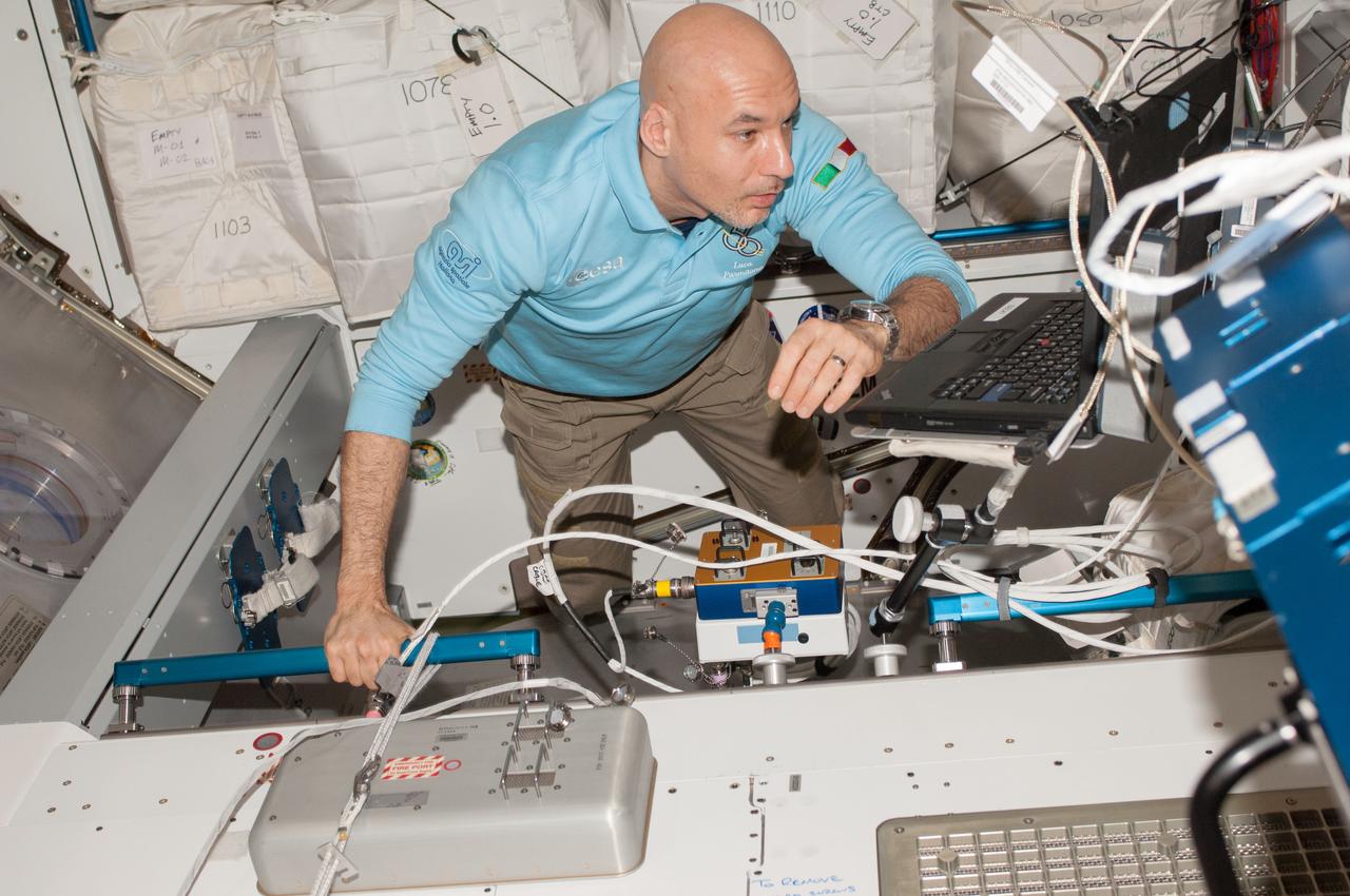 ISS037-E-001084 (15 Sept. 2013) --- European Space Agency astronaut Luca Parmitano, Expedition 37 flight engineer, installs the Common Berthing Mechanism (CBM) Centerline Berthing Camera System (CBCS) inside the International Space Station’s Harmony node.