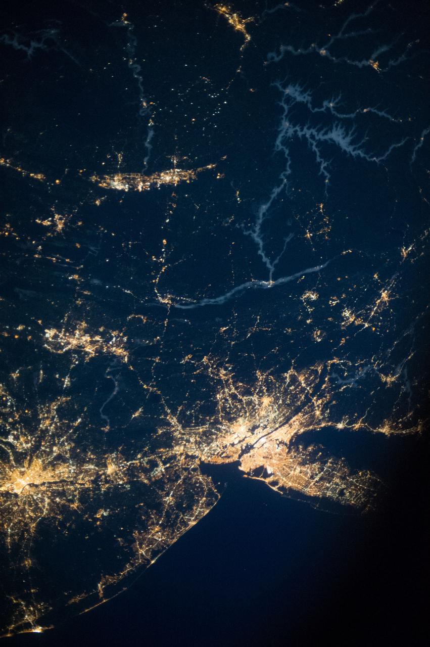 ISS037-E-001793 (20 Sept. 2013) --- One of three Expedition 37 crew members aboard the International Space Station on Sept. 20 photographed this night image showing several major cities and communities on the east coast and points west, toward the Great Lakes area. Long Island, NY is a tell-tale identifier in the lower right corner as it juts out into the Atlantic (partially obstructed by a close-up part of the orbital outpost), forming the estuary known as Long Island Sound. The New York metropolitan area is largely visible below the center of the frame.