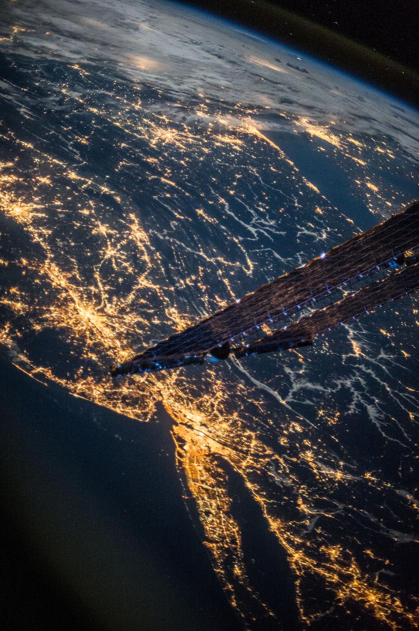ISS037-E-002225 (18 Sept. 2013) --- One of three Expedition 37 crew members aboard the International Space Station on Sept. 18 photographed this high oblique night image showing dozens of major cities and communities on the east coast and points west toward the Great Lakes area, and even areas to the southwest. Long Island, NY is a tell-tale identifier as it juts out into the Atlantic Ocean in the lower right portion of the image. The estuary known as Long Island Sound is also visible at lower right. The New York metropolitan area is largely visible below the tip of one of the space station's solar array panels.