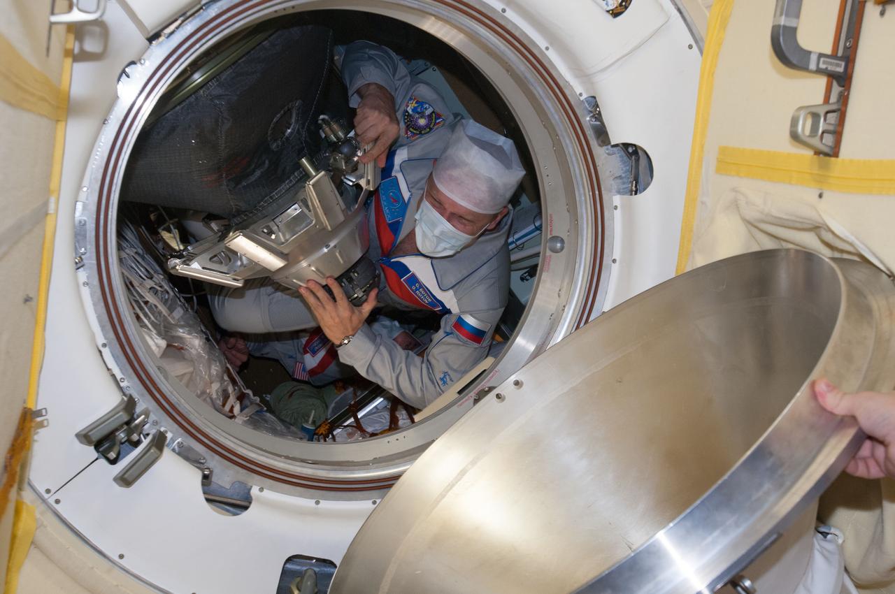 ISS037-E-002699 (25 Sept. 2013) --- Russian cosmonaut Oleg Kotov, Expedition 37 flight engineer, prepares to enter the International Space Station's Poisk Mini-Research Module 2 (MRM2) shortly after the TMA-10M spacecraft docked with the station, bringing Kotov, Russian cosmonaut Sergey Ryazanskiy and NASA astronaut Michael Hopkins to the station.
