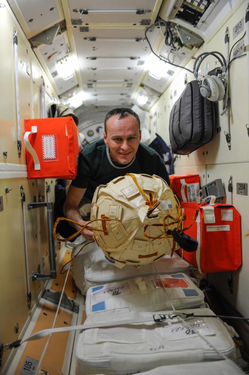 ISS037-E-003211 (27 Sept. 2013) --- Russian cosmonaut Sergey Ryazanskiy, Expedition 37 flight engineer, moves cargo in the Zarya Functional Cargo Block (FGB) of the International Space Station.
