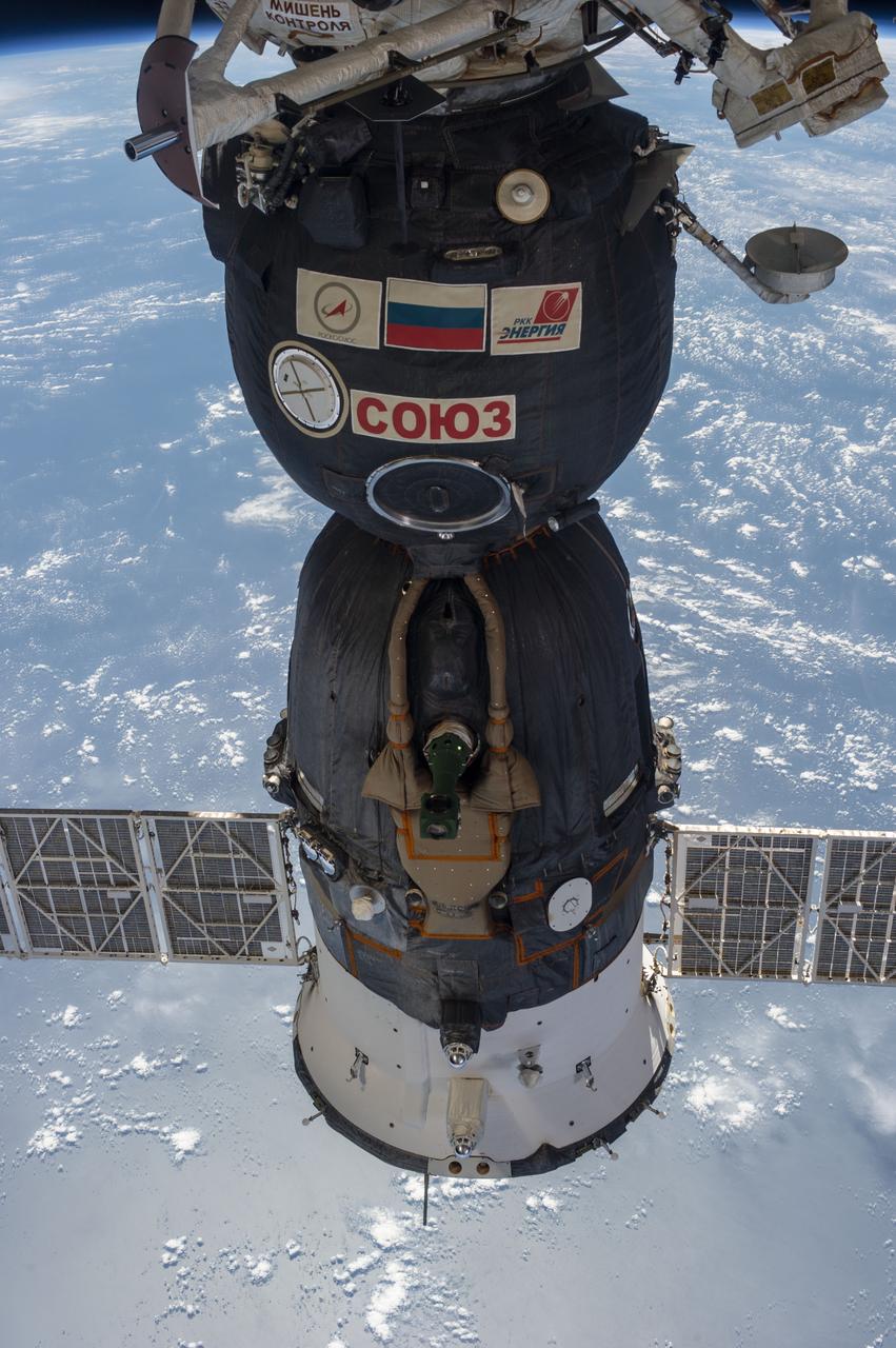ISS037-E-004184 (3 Oct. 2013) --- One of the Expedition 37 crew members on Oct. 3 exposed this frame showing a Russian Soyuz vehicle docked to the International Space Station against a backdrop of a pale blue part of Earth.