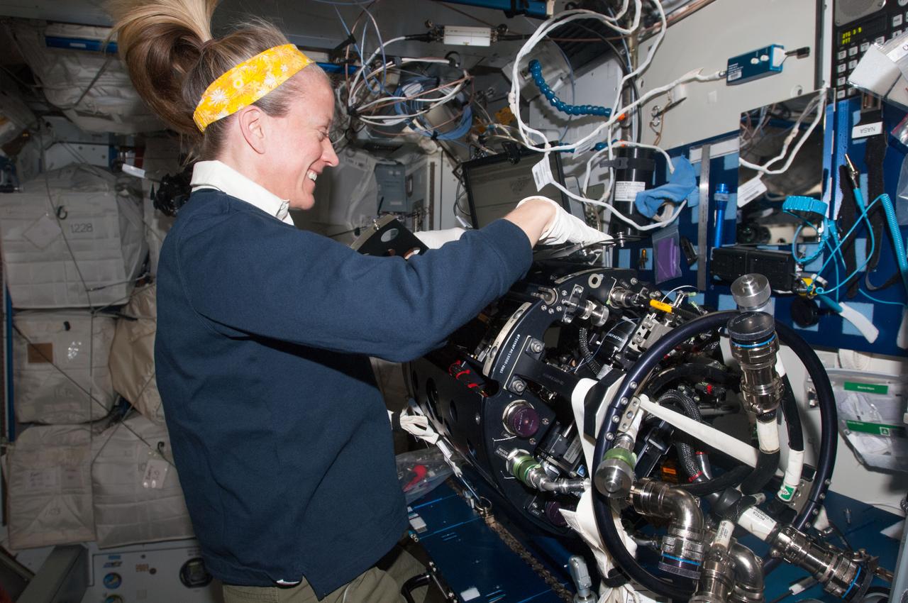 ISS037-E-004881 (1 Oct. 2013) --- NASA astronaut Karen Nyberg, Expedition 37 flight engineer, works on the Multi-User Droplet Combustion Apparatus (MDCA) Chamber Insert Assembly (CIA) at a maintenance work station in the Harmony node of the International Space Station.