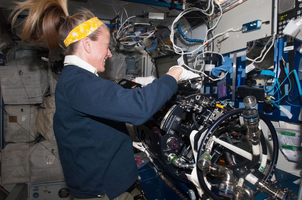 ISS037-E-004882 (1 Oct. 2013) --- NASA astronaut Karen Nyberg, Expedition 37 flight engineer, works on the Multi-User Droplet Combustion Apparatus (MDCA) Chamber Insert Assembly (CIA) at a maintenance work station in the Harmony node of the International Space Station.