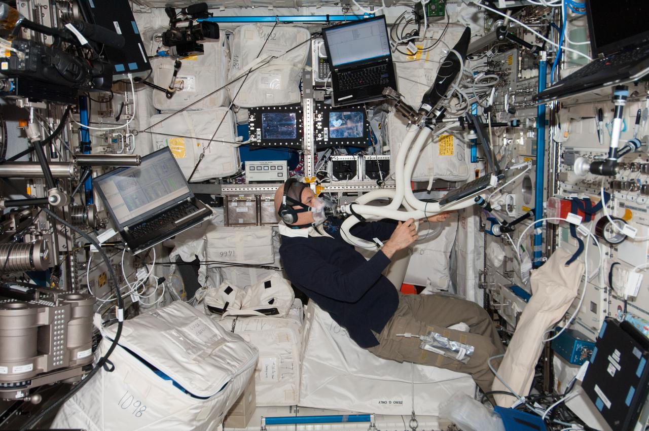 ISS037-E-004950 (2 Oct. 2013) --- European Space Agency astronaut Luca Parmitano, Expedition 37 flight engineer, performs an oxygen uptake measurement session in the Columbus laboratory of the International Space Station. He is wearing a Pulmonary Function System (PFS) face mask during the session.