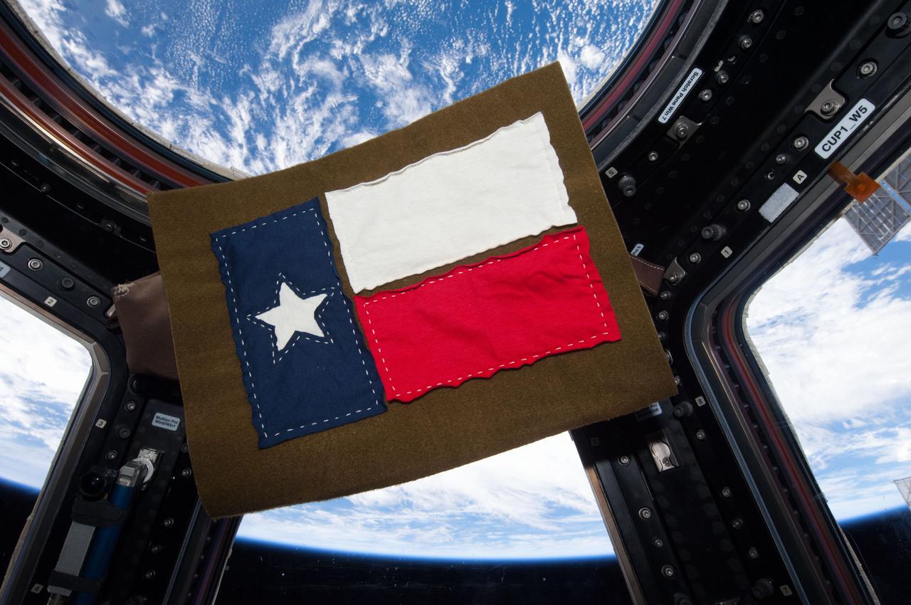 ISS037-E-004972 (27 Sept. 2013) --- Seen floating on the Cupola of the Earth-orbiting International Space Station, this quilt block, paying tribute to the state of Texas or the Lone Star state,  was fashioned from T-shirts onboard the orbital outpost by Expedition 37 Flight Engineer Karen Nyberg.  The NASA astronaut has spent much of her off-duty time on the station sewing and fashioning various items, using only a handful of tools she took aboard and whatever materials that have been available.