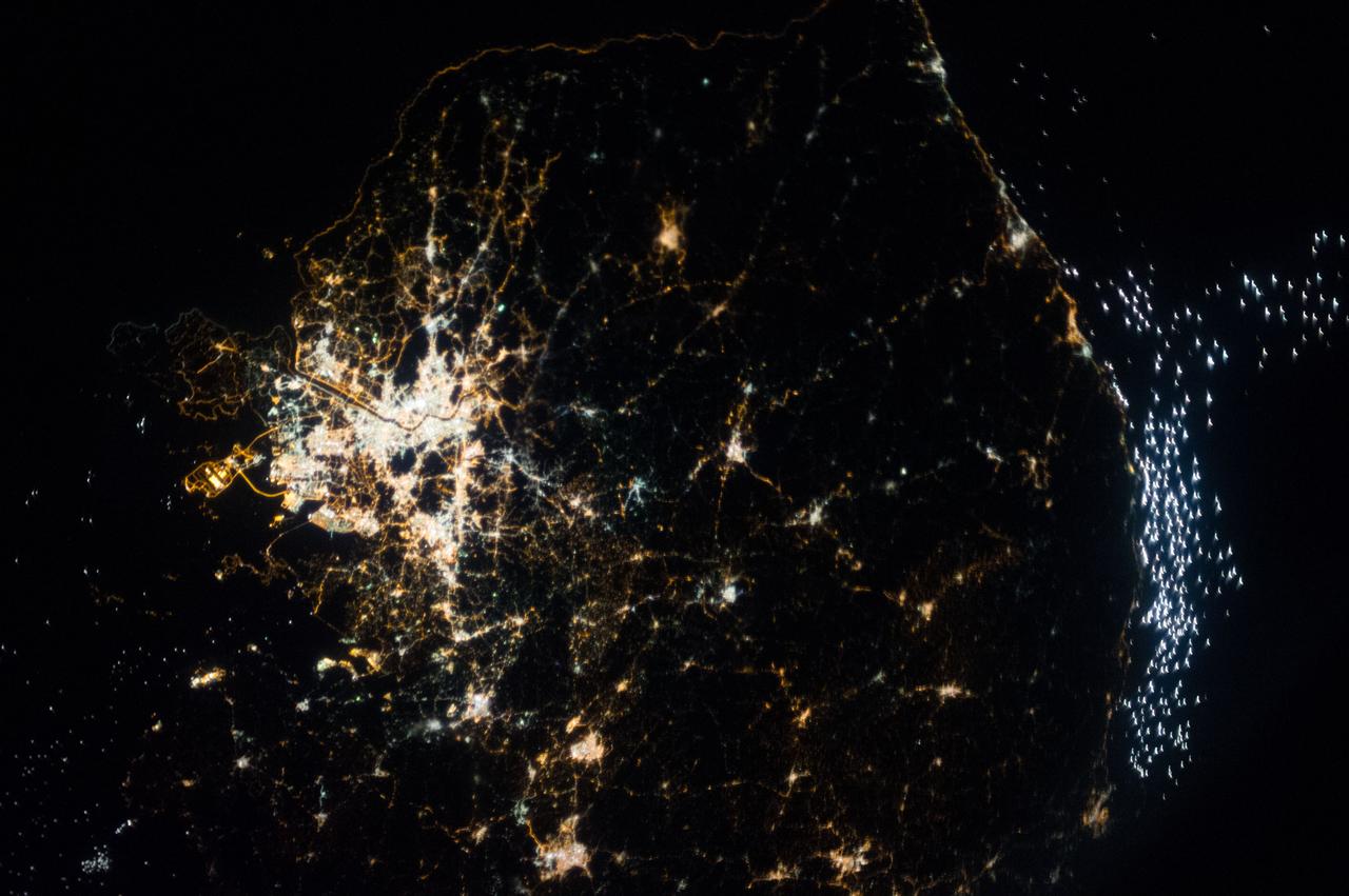 Earth observation taken during a night pass by the Expedition 37 crew. Folder lists this as Seoul, South Korea. City lights are visible. Also sent as Twitter message.