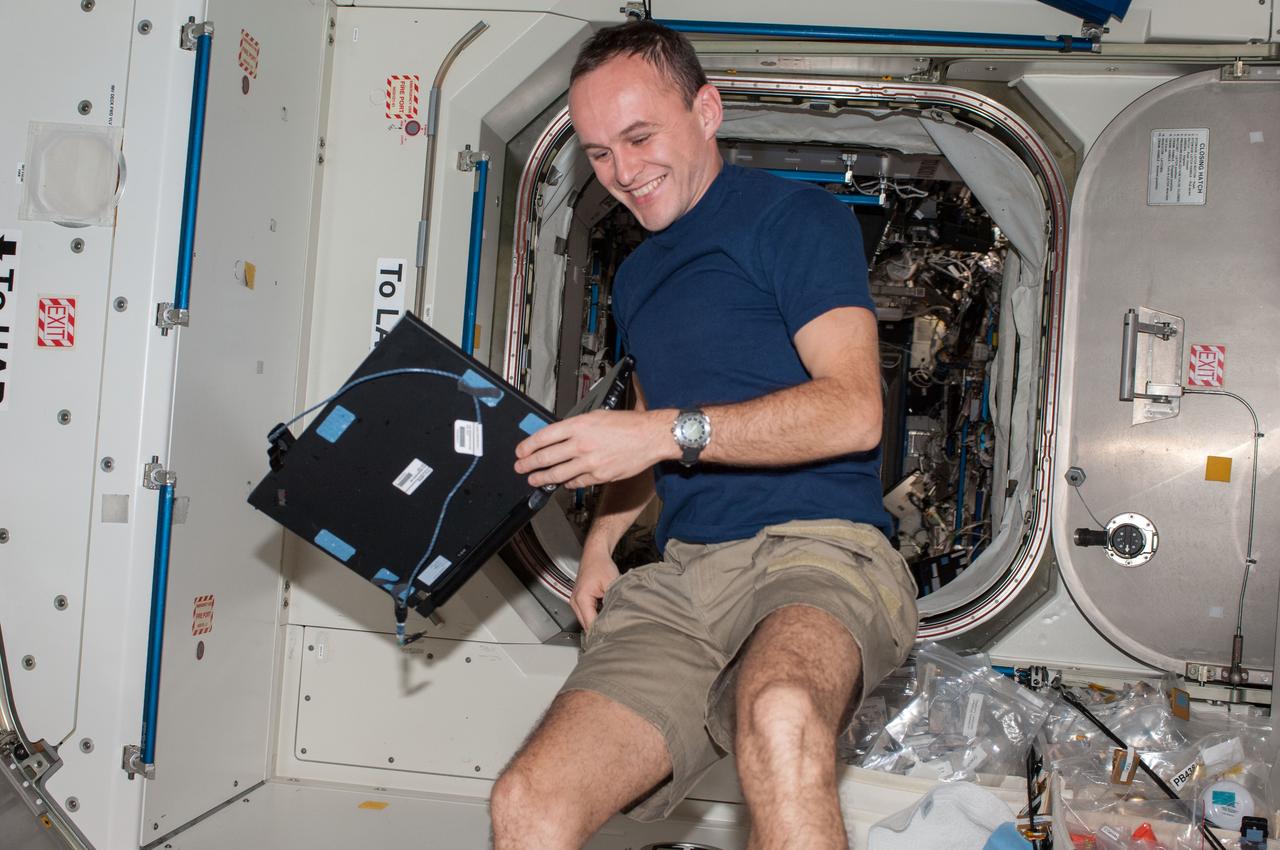 ISS037-E-005744 (2 Oct. 2013) --- Russian cosmonaut Sergey Ryazanskiy, Expedition 37 flight engineer, holds a computer in the Unity node of the International Space Station.