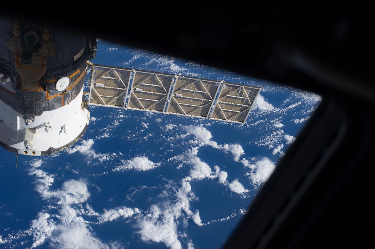 ISS037-E-005799 (3 Oct. 2013) --- One of the Expedition 37 crew members on Oct. 3 exposed this frame showing a Russian Soyuz vehicle docked to the International Space Station against a backdrop of a blue and white Earth.