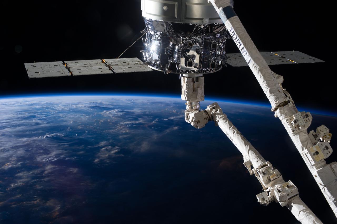 View of the first Cygnus commercial cargo spacecraft built by Orbital Sciences Corp attached to the end of the robotic arm (AKA Canadarm2) and docked the Node 2 module of the ISS. Per Twitter message: Sunrise on #Cygnus and #Canadarm2.
