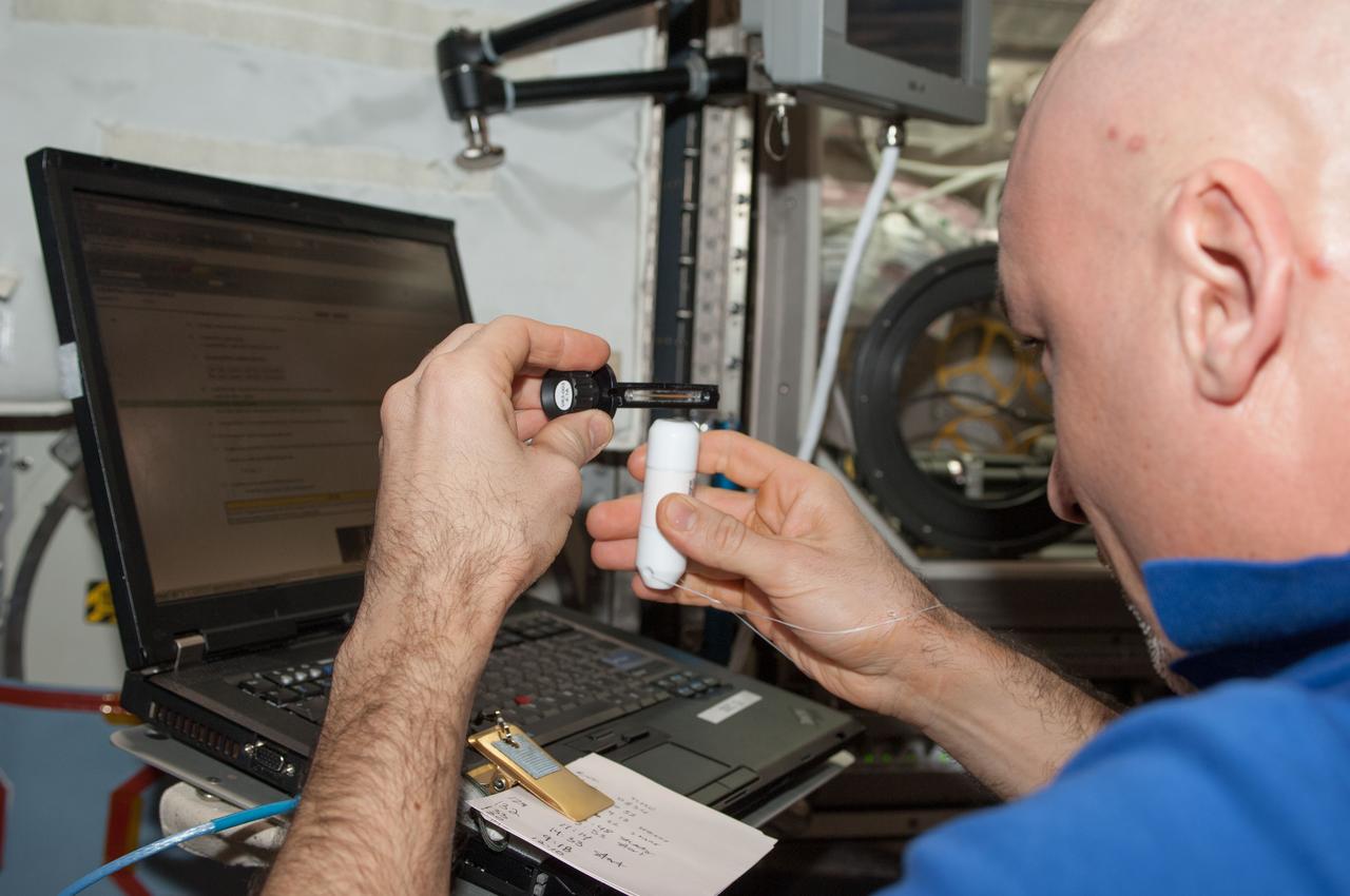 ISS037-E-010697 (14 Oct. 2013) --- European Space Agency astronaut Luca Parmitano, Expedition 37 flight engineer, works with the Investigating the Structure of Paramagnetic Aggregates from Colloidal Emulsions - 3 (InSPACE-3) experiment in the Destiny laboratory of the International Space Station.
