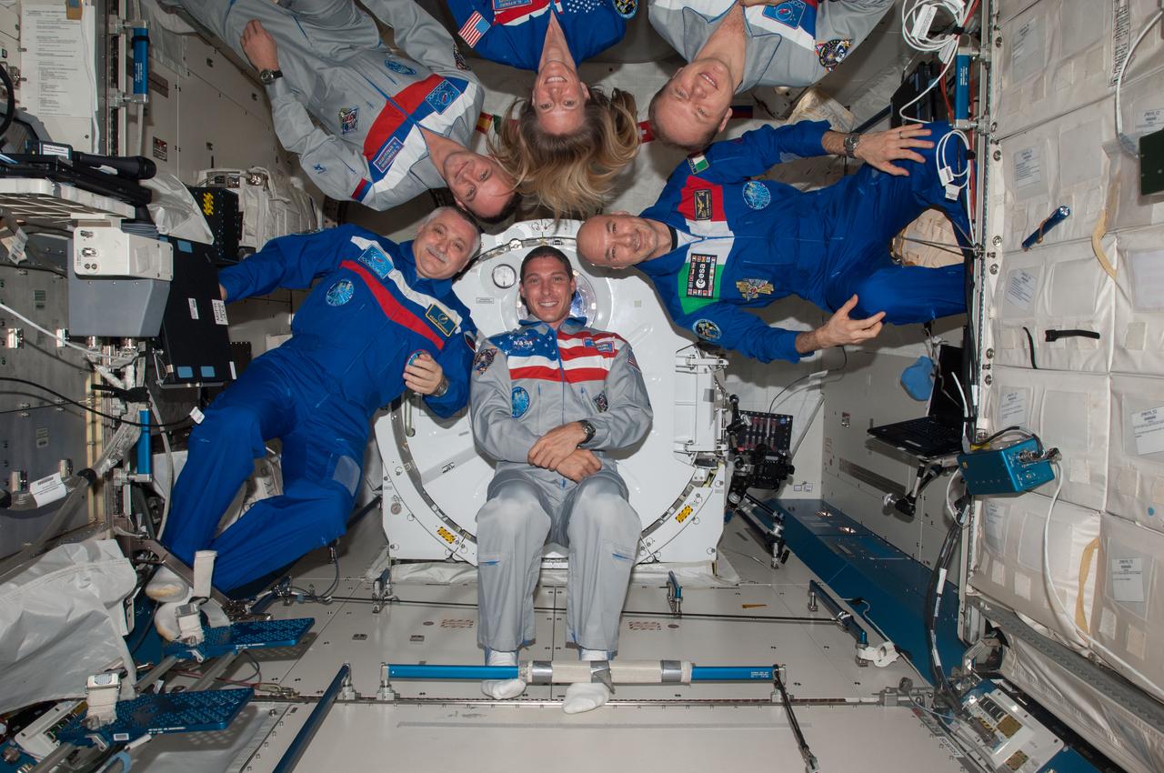 ISS037-E-011124 (14 Oct. 2013) --- Expedition 37 crew members pose for an in-flight crew portrait in the Kibo laboratory of the International Space Station. Pictured (clockwise from lower left) are Russian cosmonaut Fyodor Yurchikhin, commander; Russian cosmonauts Sergey Ryazanskiy, NASA astronaut Karen Nyberg, Russian cosmonaut Oleg Kotov, European Space Agency astronaut Luca Parmitano and NASA astronaut Michael Hopkins, all flight engineers.