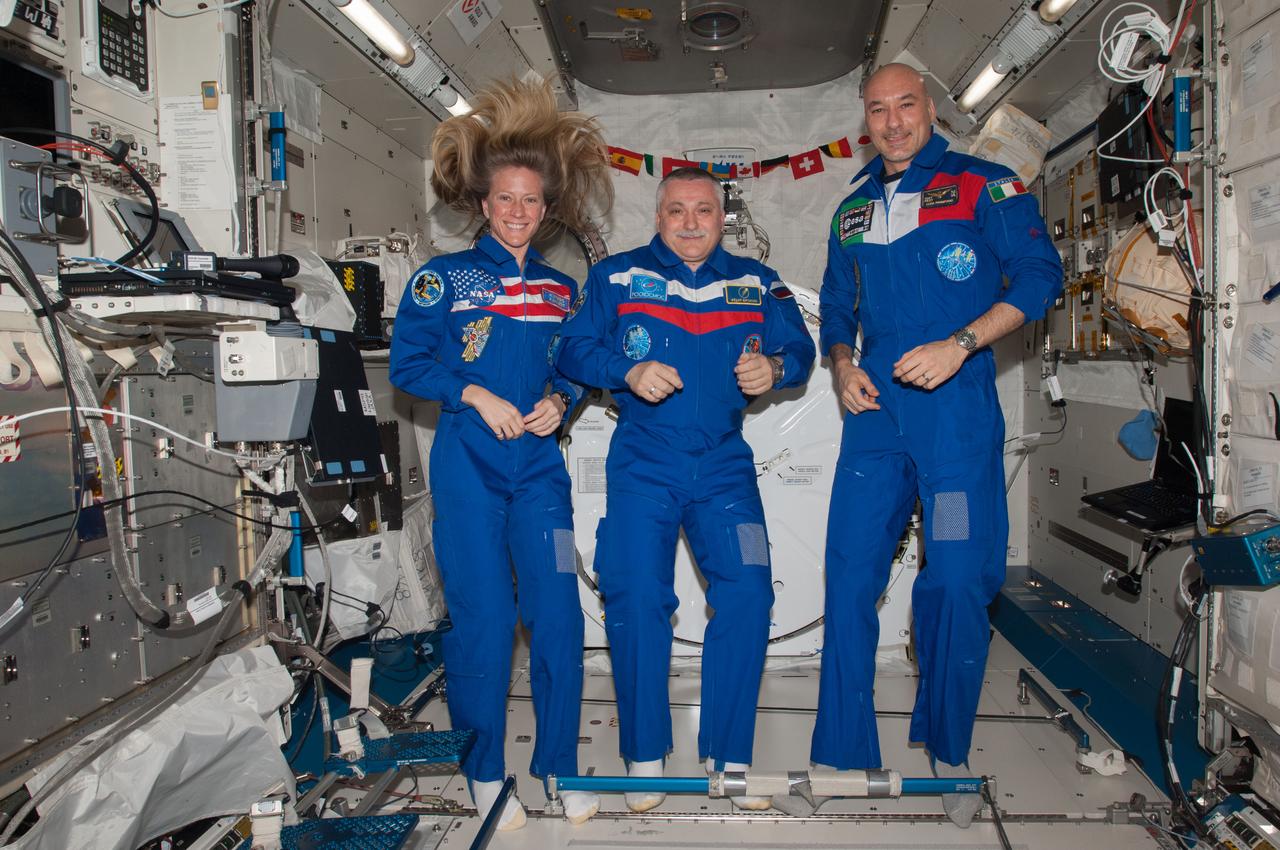 ISS037-E-011135 (14 Oct. 2013) --- Russian cosmonaut Fyodor Yurchikhin (center), Expedition 37 commander; along with NASA astronaut Karen Nyberg and European Space Agency astronaut Luca Parmitano, both flight engineers, pose for a portrait in the Kibo laboratory of the International Space Station.