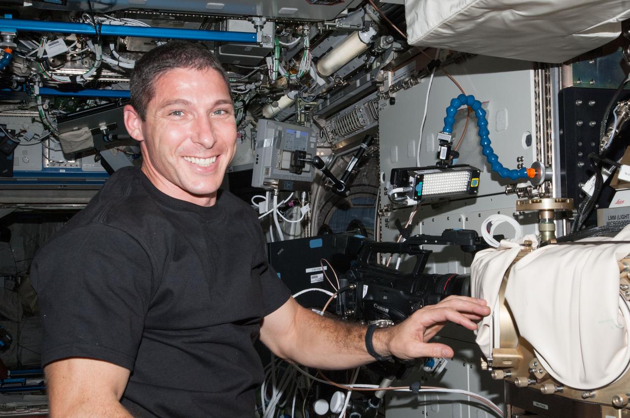 ISS037-E-012572 (14 Oct. 2013)  --- In the U.S. lab Destiny aboard the Earth-orbiting International Space Station Expedition 37 Flight Engineer Michael Hopkins prepares the Fluids Integrated Rack for an experiment.