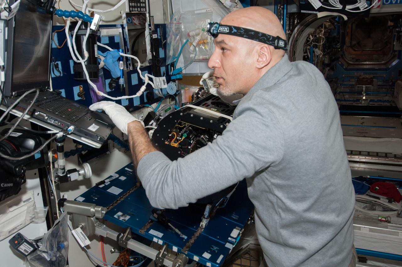 ISS037-E-012579 (10 Oct. 2013) --- European Space Agency astronaut Luca Parmitano, Expedition 37 flight engineer, works on the Multi-User Droplet Combustion Apparatus (MDCA) Chamber Insert Assembly (CIA) at a maintenance work station in the Harmony node of the International Space Station.