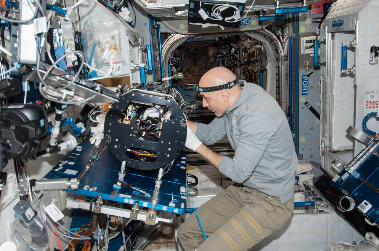 ISS037-E-012586 (10 Oct. 2013) --- European Space Agency astronaut Luca Parmitano, Expedition 37 flight engineer, works on the Multi-User Droplet Combustion Apparatus (MDCA) Chamber Insert Assembly (CIA) at a maintenance work station in the Harmony node of the International Space Station.