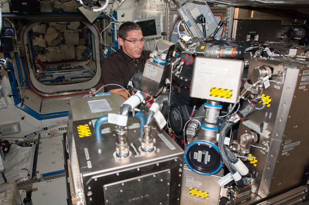 ISS037-E-013602 (15 Oct. 2013) --- NASA astronaut Michael Hopkins, Expedition 37 flight engineer, works on the Combustion Integrated Rack (CIR) in the Destiny laboratory of the International Space Station.