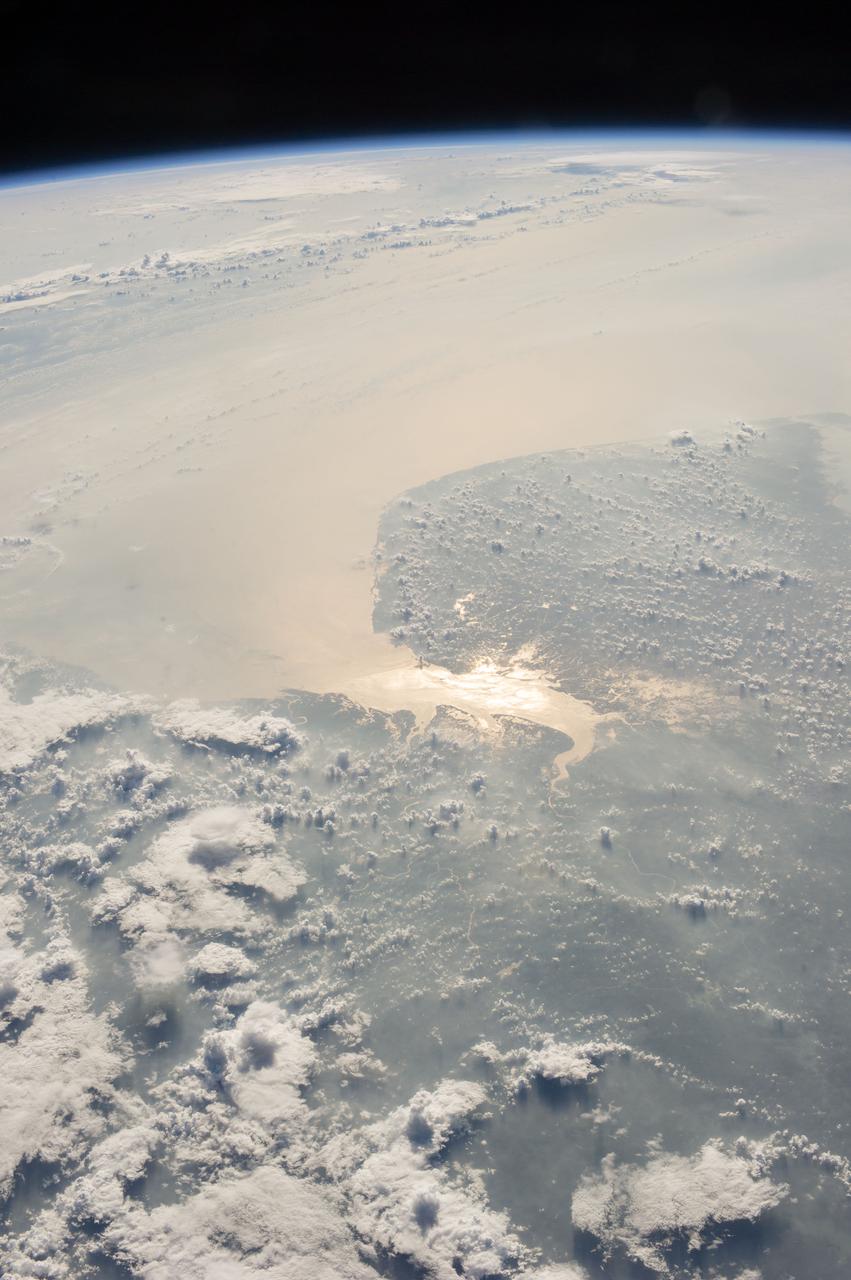 Earth observation taken during a day pass by the Expedition 37 crew. Per Twitter message: Sun glint on the Gulf of Khambhat, India.