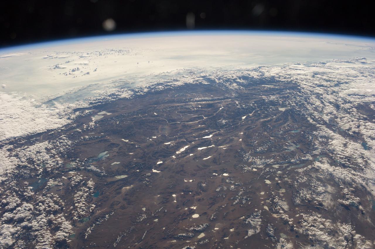 Earth observation taken during a day pass by the Expedition 37 crew. View identified via Twitter message as the Tibetan Plateau.