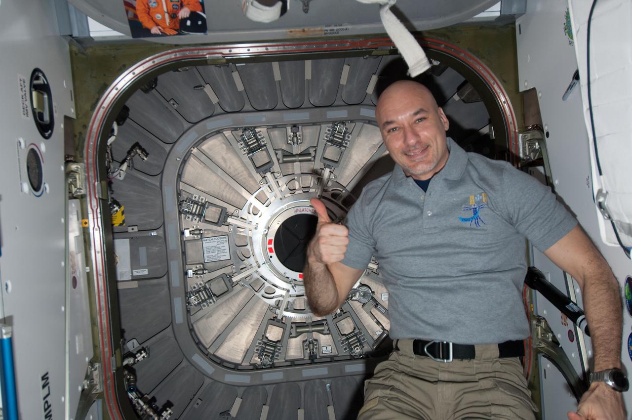ISS037-E-016758 (21 Oct. 2013) --- European Space Agency astronaut Luca Parmitano, Expedition 37 flight engineer, gives a thumbs up signal after closing the hatch between the International Space Station’s Harmony node and the Orbital Sciences’ Cygnus commercial cargo spacecraft in preparation for its release after completing a successful demonstration mission to the space station. Cygnus delivered 1,300 pounds of gear on Sept. 29 when it arrived and was captured by Canadarm2 and berthed to the Harmony node.