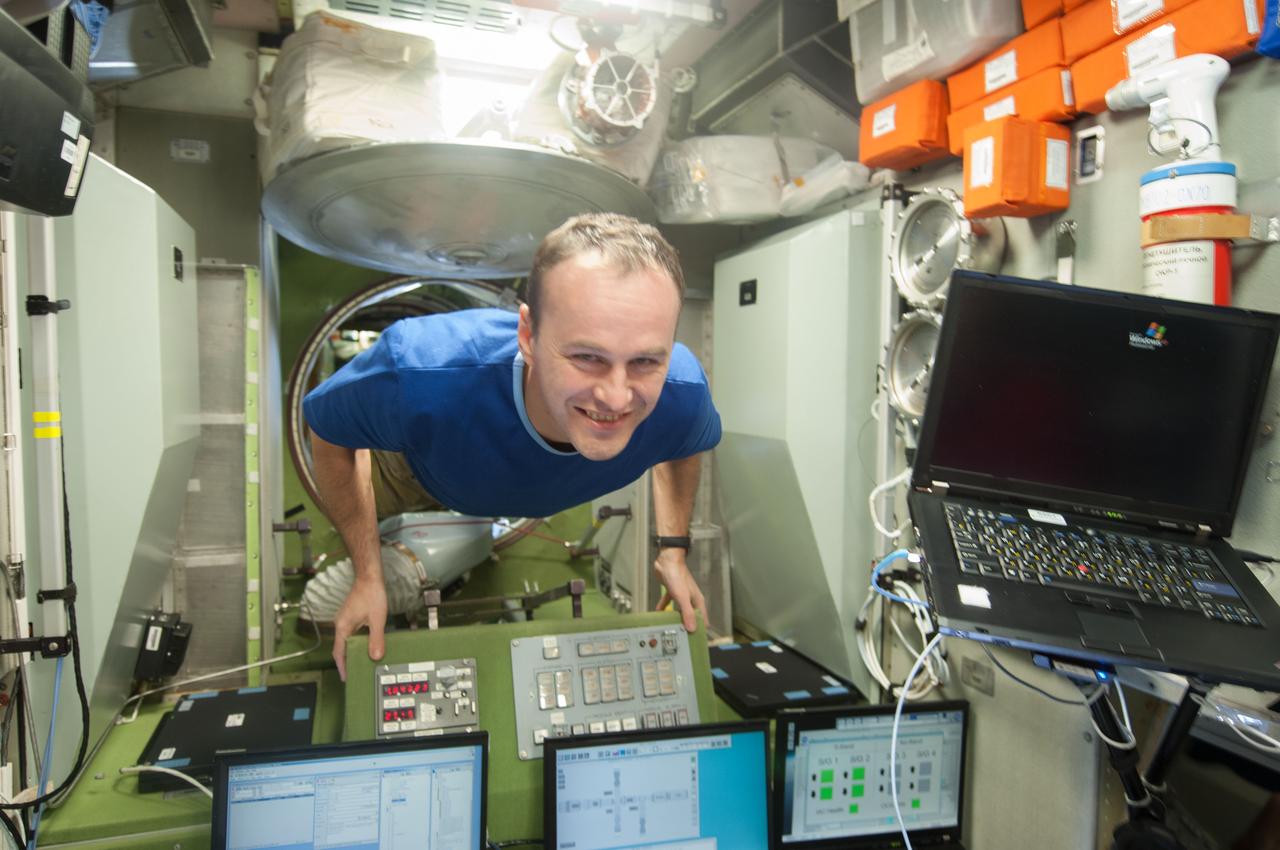 ISS037-E-016947 (19 Oct. 2013) --- Russian cosmonaut Sergey Ryazanskiy, Expedition 37 flight engineer, floats through a hatch in the Russian segment of the International Space Station.