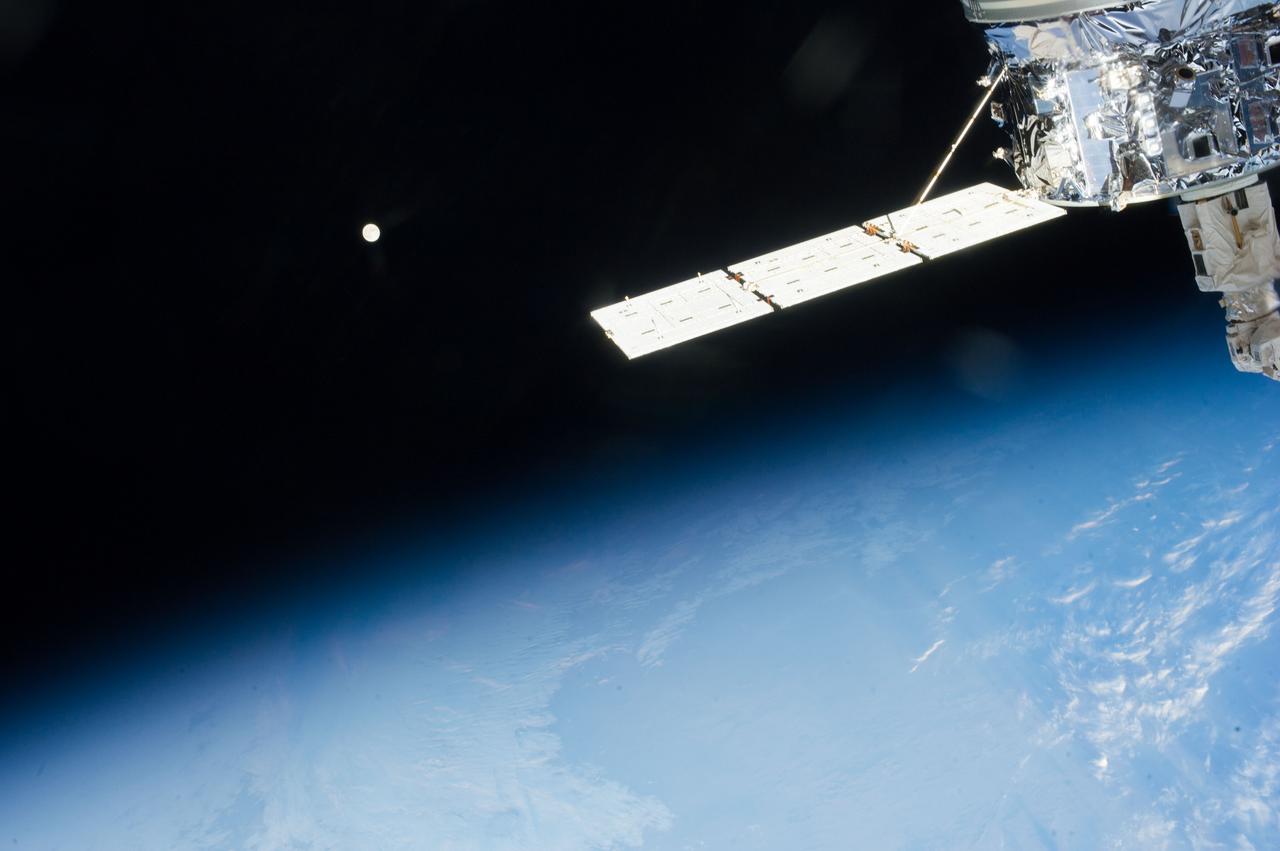 ISS037-E-017169 (19 Oct. 2013) --- The European Space Agency's fourth Automated Transfer Vehicle (ATV-4), also known as the Albert Einstein, is seen in the foreground of  an image featuring the home planet and its moon as photographed by one of Expedition 37 crew members aboard the Earth-orbiting International Space Station.