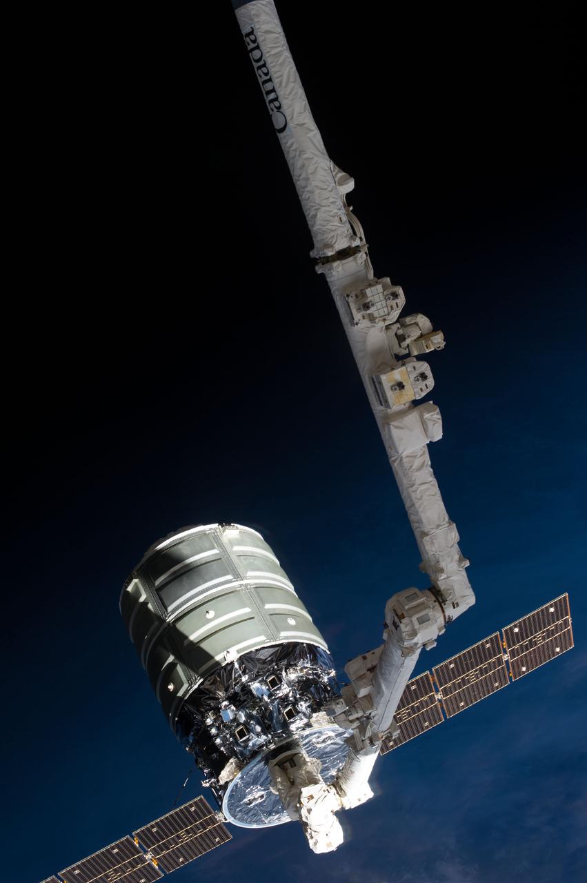 ISS037-E-018544 (22 Oct. 2013) --- The International Space Station’s Canadarm2 prepares to release the Orbital Sciences’ Cygnus commercial craft after three weeks at the space station. European Space Agency astronaut Luca Parmitano and NASA astronaut Karen Nyberg, both Expedition 37 flight engineers, were at the controls of the robotics workstation removing Cygnus from the Harmony node then safely releasing it at 7:31 a.m. (EDT) Oct. 22, 2013. On Oct. 23, the Cygnus will fire its engines for the last time at 1:41 p.m. and re-enter Earth’s atmosphere for destruction over the Pacific Ocean.