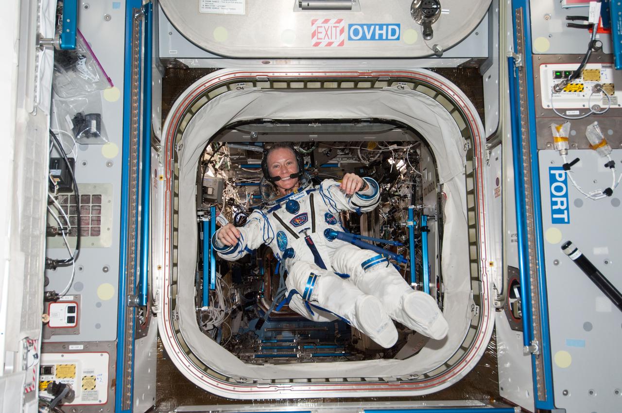 ISS037-E-022011 (28 Oct. 2013) --- Attired in a Russian Sokol launch and entry suit, NASA astronaut Karen Nyberg, Expedition 37 flight engineer, floats freely in the Harmony node of the International Space Station.