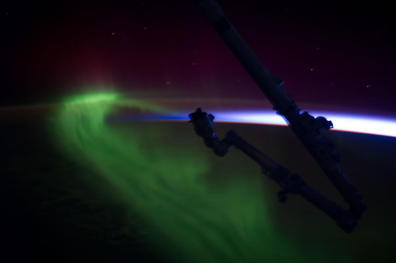 ISS037-E-022828 (30 Oct. 2013) --- This isn?t someone?s frame grab of a decorative Halloween scene, although it was photographed on Halloween eve.  It is actually a picture of the Aurora Australis or Southern Lights, photographed by one of the Expedition 37 crew members on the International Space Station as the orbital complex flew over Tasmania on Oct. 30. The human-produced hardware in the picture is part of the outpost?s robotic arm system.