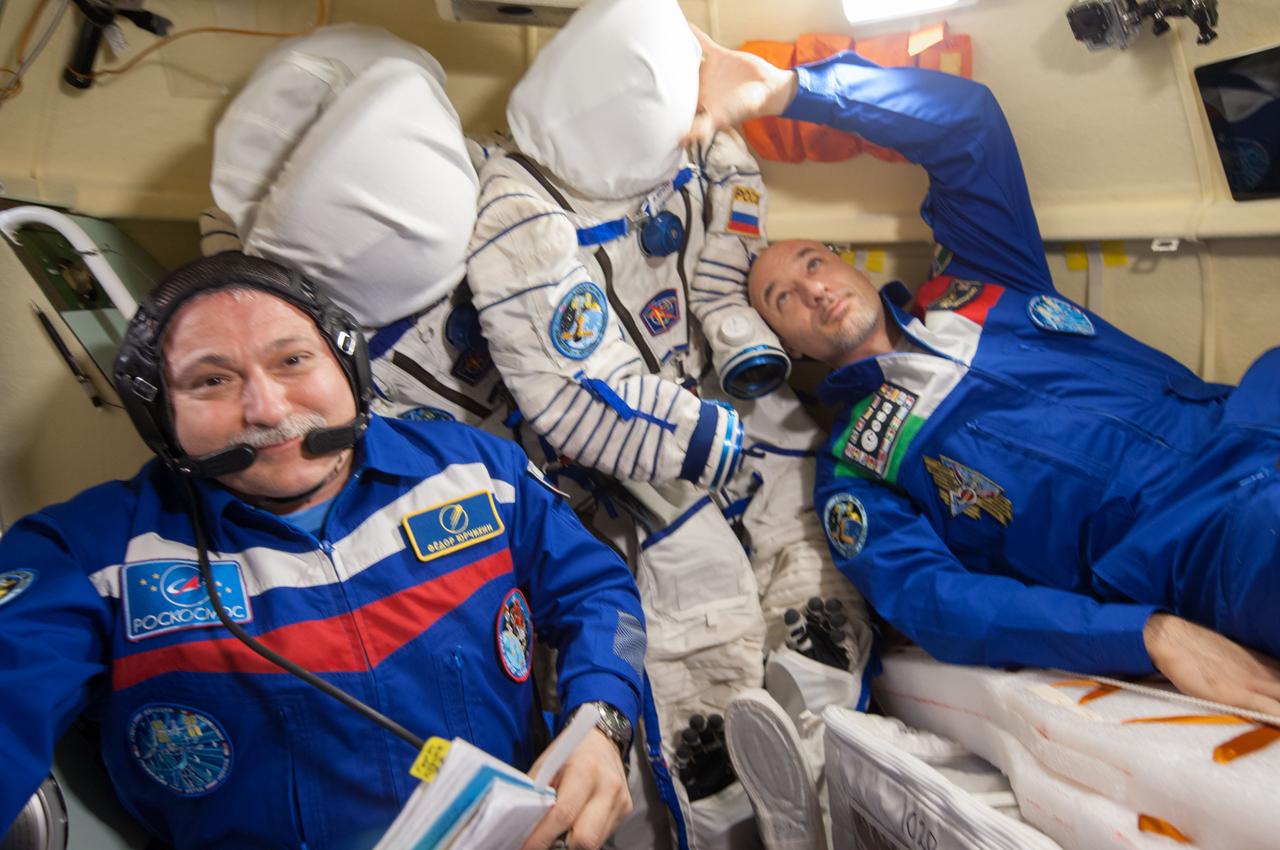 ISS037-E-024927 (31 Oct. 2013) --- Russian cosmonaut Fyodor Yurchikhin (left), Expedition 37 commander, and European Space Agency astronaut Luca Parmitano, flight engineer, prepare to relocate their Soyuz TMA-09M spacecraft from the International Space Station?s Rassvet module to the aft port of the Zvezda Service Module. Along with NASA astronaut Karen Nyberg, they are scheduled to undock their spacecraft at 4:34 a.m. (EDT) on Nov. 1 for the planned 24-minute maneuver.