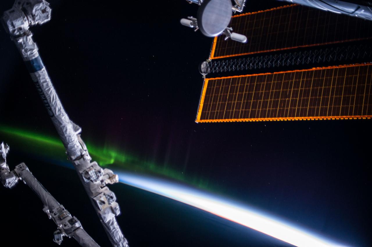 ISS037-E-026748 (4 Nov. 2013) --- One of the Expedition 37 crew members aboard the Earth-orbiting International Space Station took this photograph looking toward Earth's horizon when the complex was 228 miles above a point located 46.6 degrees south latitude and 146.6 degrees east longitude. The space station remote manipulator system arm or Canadarm2 dominates the foreground.  A relatively small appearance of Aurora Australis or the Southern Lights runs from upper left toward frame center. One of the space station's solar array panels is seen in upper right.