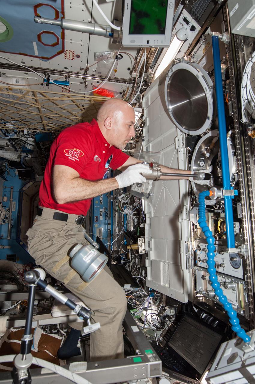 ISS037-E-026918 (4 Nov. 2013) --- European Space Agency astronaut Luca Parmitano, Expedition 37 flight engineer, works with the Combustion Integrated Rack (CIR) Multi-user Drop Combustion Apparatus (MDCA) in the Destiny laboratory of the International Space Station.