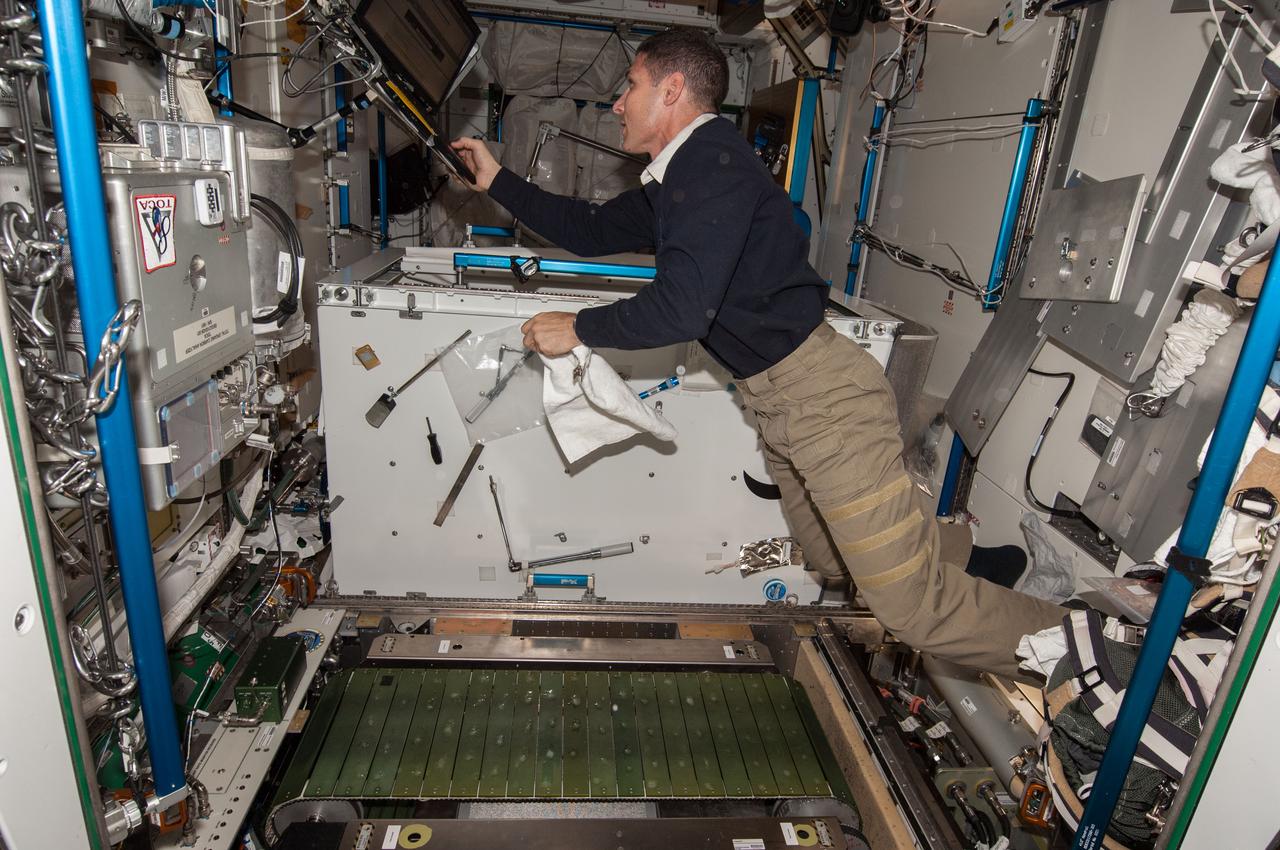 ISS037-E-026920 (4 Nov. 2013) --- NASA astronaut Michael Hopkins, Expedition 37 flight engineer, enters data in a computer near the Combined Operational Load Bearing External Resistance Treadmill (COLBERT) in the Tranquility node of the International Space Station.