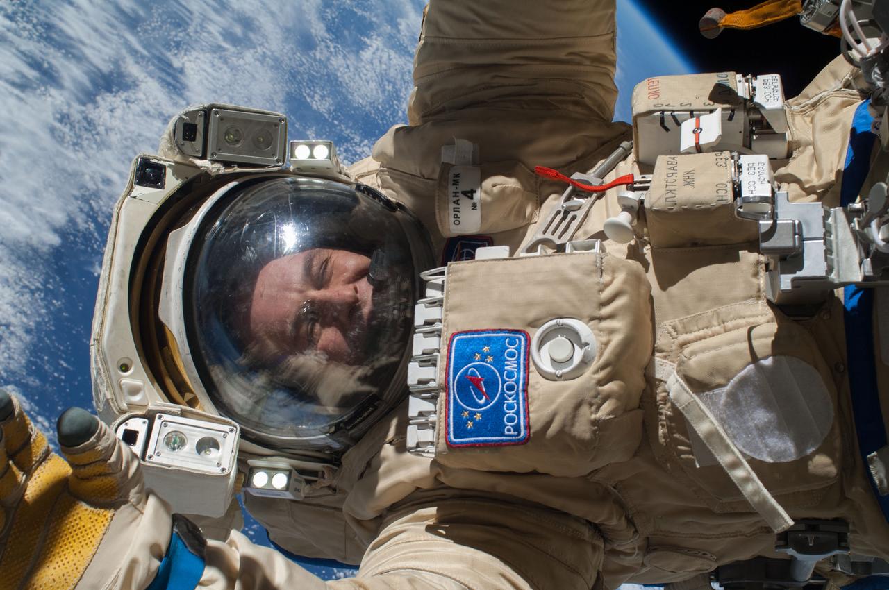 ISS037-E-028082 (9 Nov. 2013) --- Russian cosmonaut Sergey Ryazanskiy, Expedition 37 flight engineer, attired in a Russian Orlan spacesuit, participates in a session of extravehicular activity (EVA) in support of assembly and maintenance on the International Space Station. During the five-hour, 50-minute spacewalk, Ryazanskiy and Russian cosmonaut Oleg Kotov (out of frame) continued the setup of a combination EVA workstation and biaxial pointing platform that was installed during an Expedition 36 spacewalk on Aug. 22.