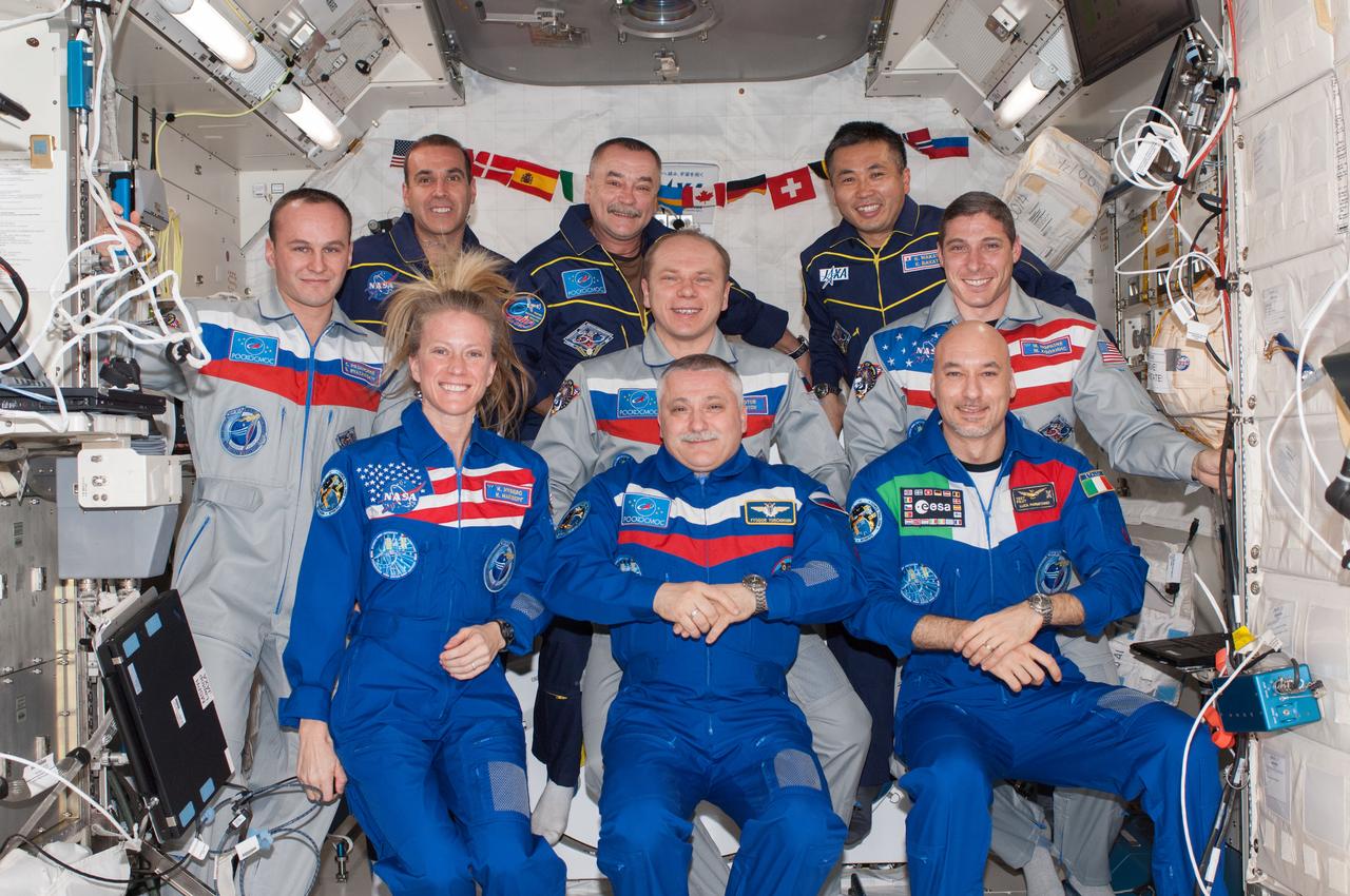 Nine crew members gather for a group portrait in the International Space Stations Kibo laboratory following a joint crew news conference. This is the first time since October 2009 that nine people have resided on the station without the presence of a space shuttle. Pictured on the front row are Russian cosmonaut Fyodor Yurchikhin (center),Expedition 37 commander; NASA astronaut Karen Nyberg and European Space Agency astronaut Luca Parmitano,both Expedition 37 flight engineers. Pictured on the center row are Russian cosmonaut Oleg Kotov (center),Expedition 38 commander; Russian cosmonaut Sergey Ryazanskiy (left) and NASA astronaut Michael Hopkins,both Expedition 38 flight engineers. Pictured from the left (back row) are NASA astronaut Rick Mastracchio,Russian cosmonaut Mikhail Tyurin and Japan Aerospace Exploration Agency astronaut Koichi Wakata,all Expedition 38 flight engineers. The Expedition 37 crew members will undock from the station in their Soyuz TMA-09M spacecraft on Nov. 10,ending a five-and-a-half month stay.