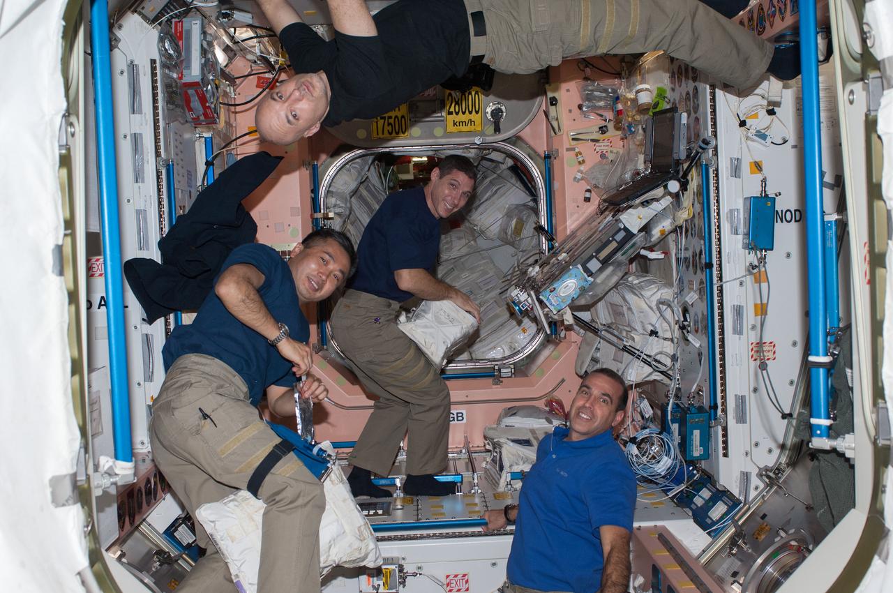ISS037-E-028300 (8 Nov. 2013) --- Four of the nine crew members on the International Space Station work in the Unity node. Pictured at top is European Space Agency astronaut Luca Parmitano, Expedition 37 flight engineer. Pictured from bottom left are Japan Aerospace Exploration Agency astronaut Koichi Wakata, NASA astronauts Michael Hopkins and Rick Mastracchio, all Expedition 38 flight engineers.