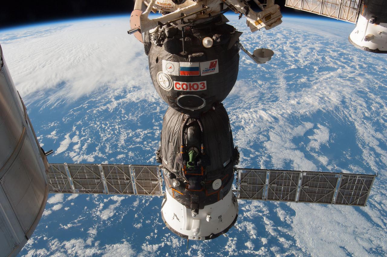 ISS038-E-000250 (12 Nov. 2013) --- The Russian Soyuz TMA-11M spacecraft dominates this image exposed by one of the Expedition 38 crew members aboard the International Space Station over Earth on Nov. 12. Now docked to the Rassvet or Mini-Research Module 1 (MRM-1), the spacecraft had delivered three crew members to the orbital outpost five days earlier, temporarily bringing the total population to nine aboard the station.