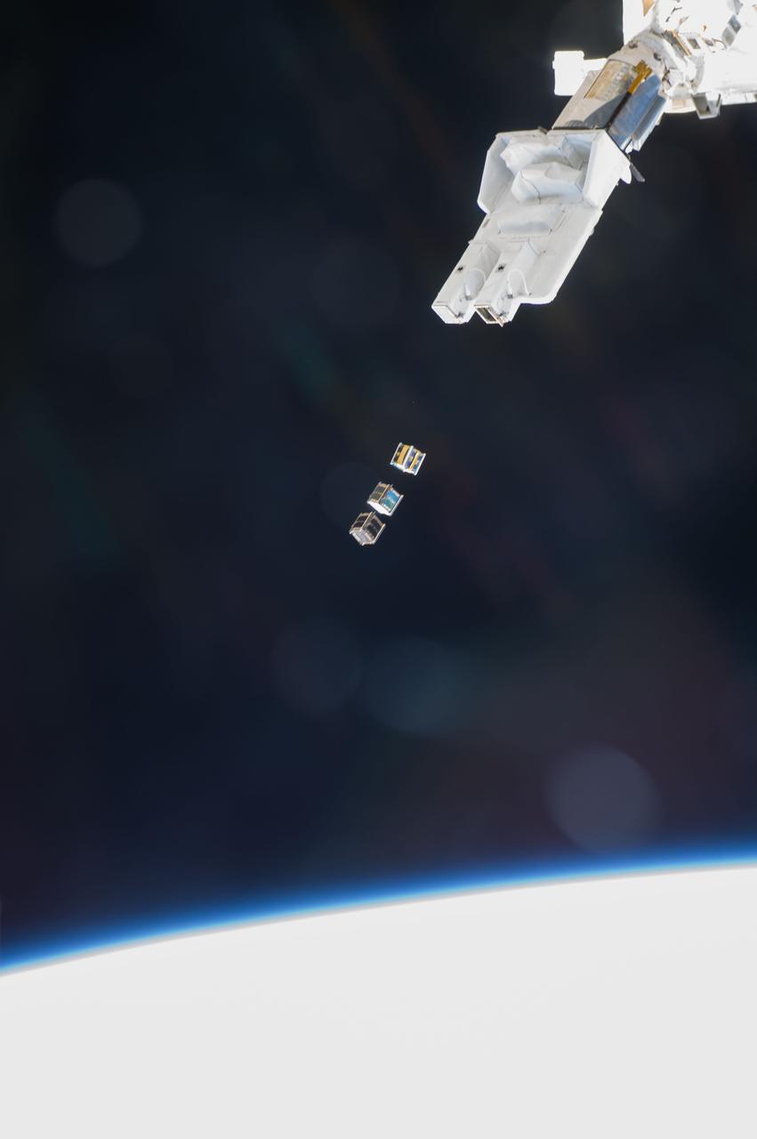 ISS038-E-003870 (19 Nov. 2013) --- Three nanosatellites, known as Cubesats, are deployed from a Small Satellite Orbital Deployer (SSOD) attached to the Kibo laboratory’s robotic arm at 7:10 a.m. (EST) on Nov. 19, 2013. Japan Aerospace Exploration Agency astronaut Koichi Wakata, Expedition 38 flight engineer, monitored the satellite deployment while operating the Japanese robotic arm from inside Kibo. The Cubesats were delivered to the International Space Station Aug. 9, aboard Japan’s fourth H-II Transfer Vehicle, Kounotori-4.