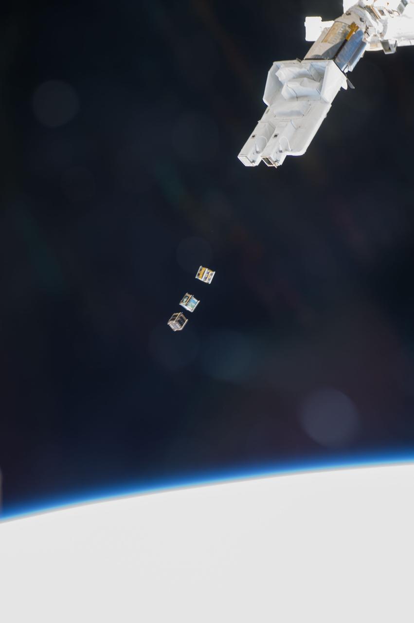 ISS038-E-003871 (19 Nov. 2013) --- Three nanosatellites, known as Cubesats, are deployed from a Small Satellite Orbital Deployer (SSOD) attached to the Kibo laboratory’s robotic arm at 7:10 a.m. (EST) on Nov. 19, 2013. Japan Aerospace Exploration Agency astronaut Koichi Wakata, Expedition 38 flight engineer, monitored the satellite deployment while operating the Japanese robotic arm from inside Kibo. The Cubesats were delivered to the International Space Station Aug. 9, aboard Japan’s fourth H-II Transfer Vehicle, Kounotori-4.