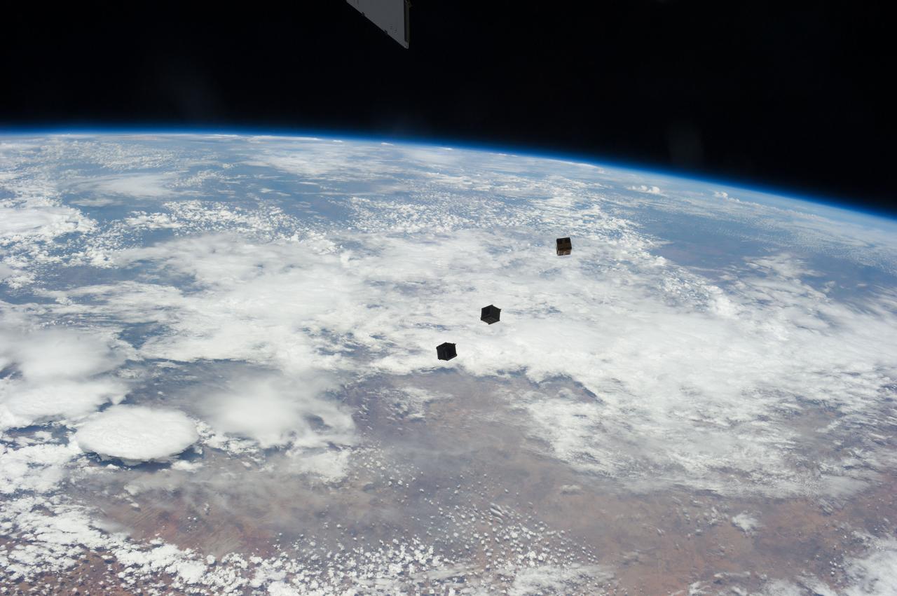 View of three cube satellites (Cubesats), or nanosatellites, shortly after deployment.  Image was released by astronaut on Twitter.