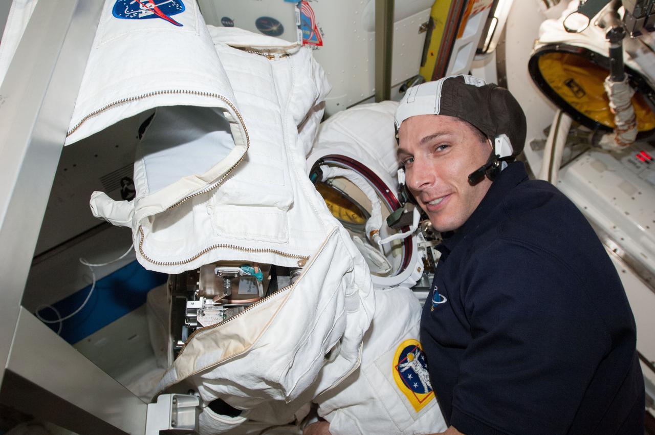 ISS038-E-004128 (18 Nov. 2013) --- NASA astronaut Michael Hopkins, Expedition 38 flight engineer, participates in Extravehicular Mobility Unit (EMU) spacesuit tests and repairs in the Quest airlock of the International Space Station.