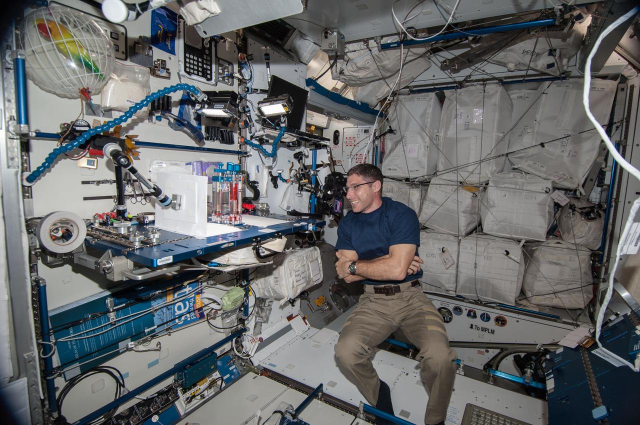 ISS038-E-005962 (19 Nov. 2013) --- NASA astronaut Michael Hopkins, Expedition 38 flight engineer, conducts a session with the Capillary Flow Experiment (CFE-2) in the Harmony node of the International Space Station. CFE is a suite of fluid physics experiments that investigate how fluids behave in microgravity which could benefit water and fuel delivery systems on future spacecraft. Scientists designed the Capillary Flow Experiment-2 to study properties of fluids and bubbles inside containers with a specific 3-D geometry.